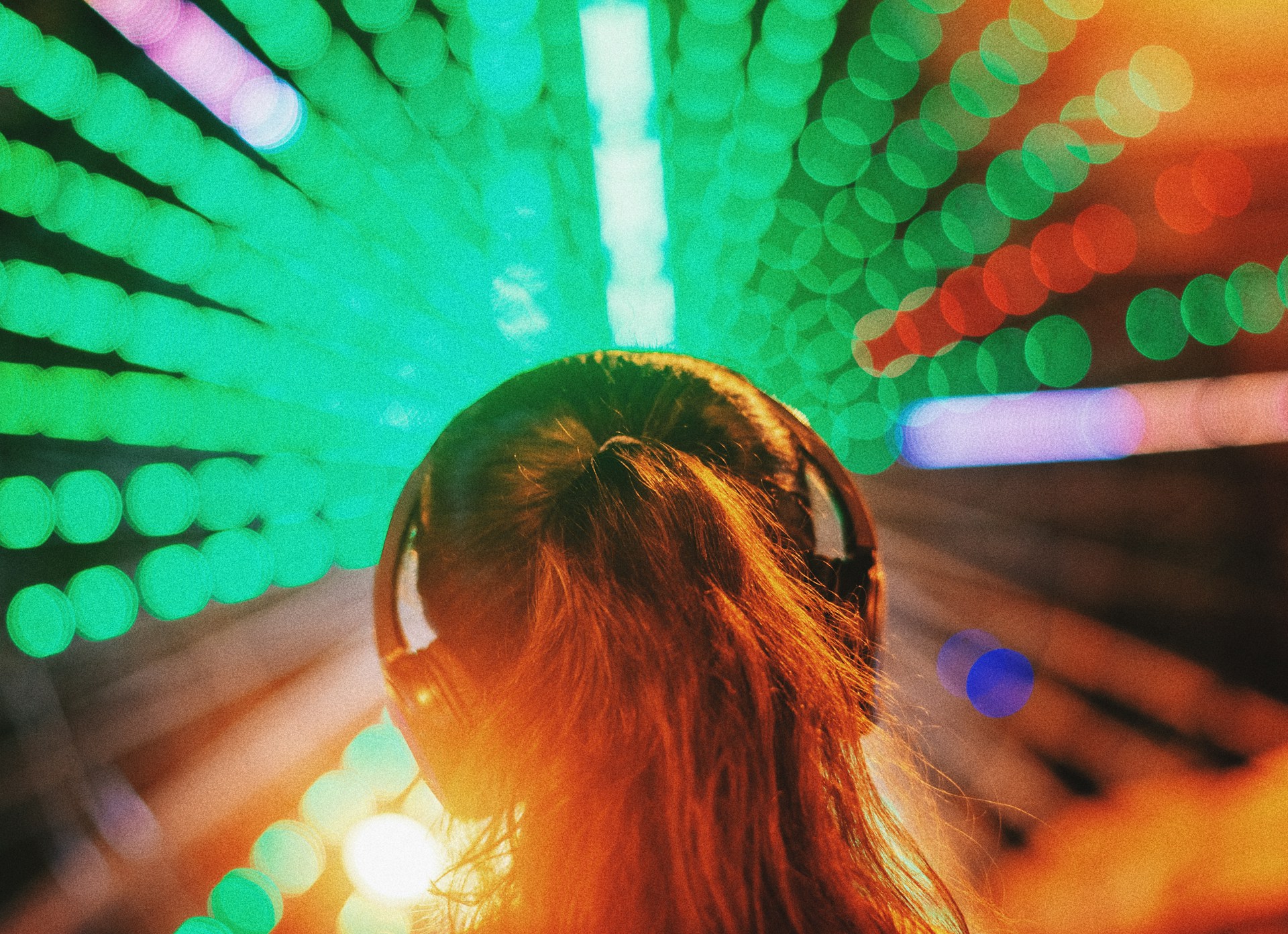 A woman wearing a headset in a colourful space